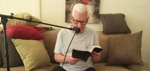 Steve Sumrall reading from the bible into a microphone